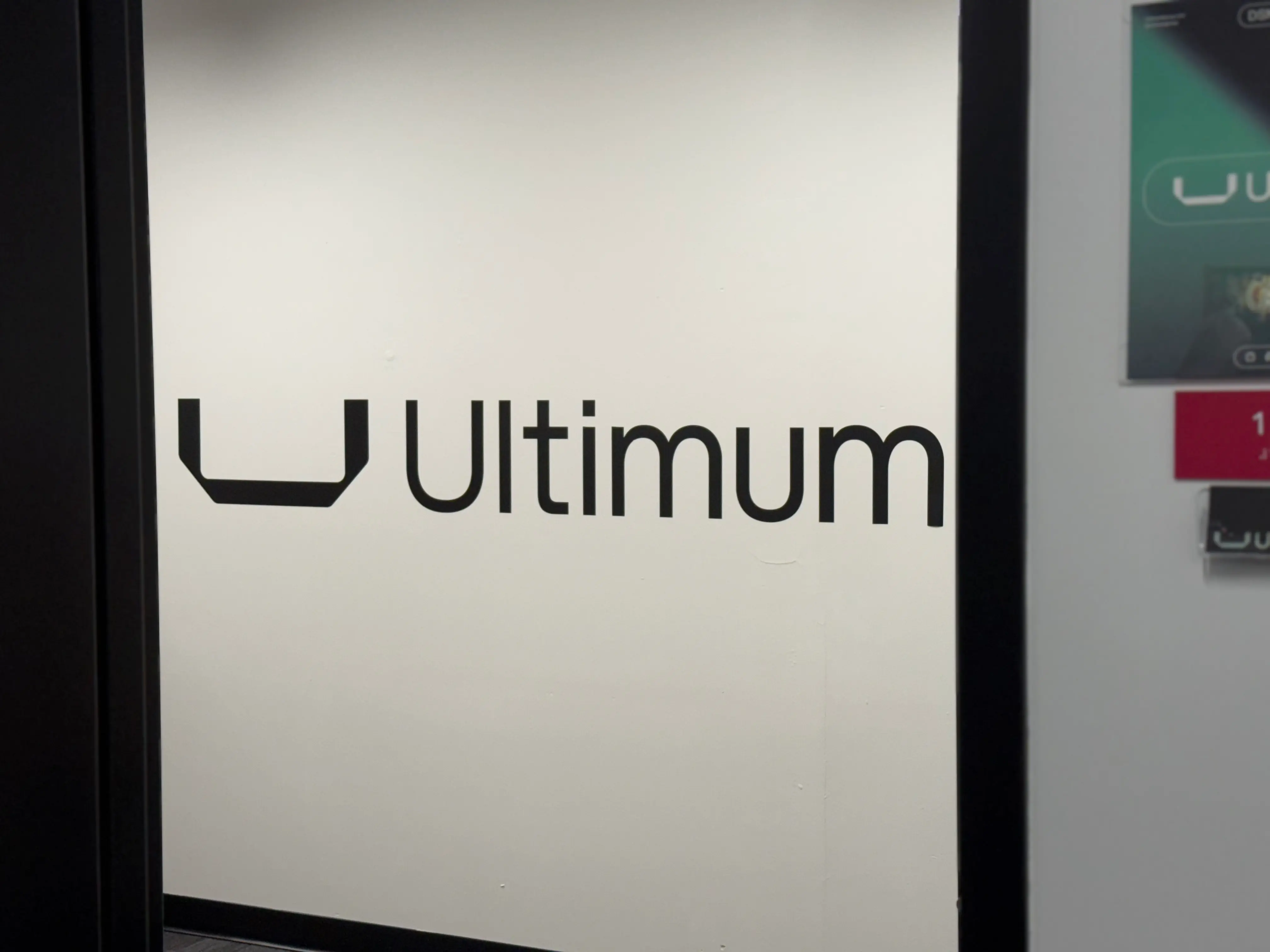 Ultimum Group office sign visible through the entrance to their Des Moines headquarters